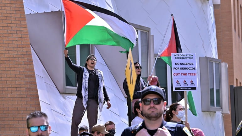 Pro-Palestinian demonstrators wave flags outside the Stata Center at MIT,...