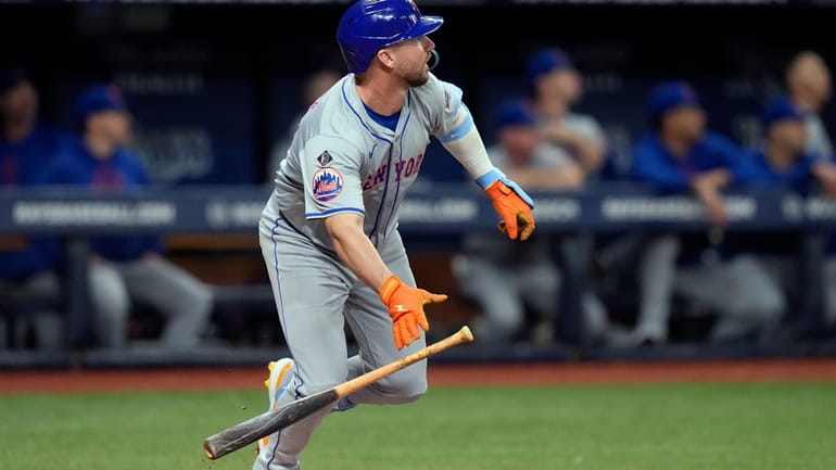 New York Mets' Pete Alonso watches his RBI double off...