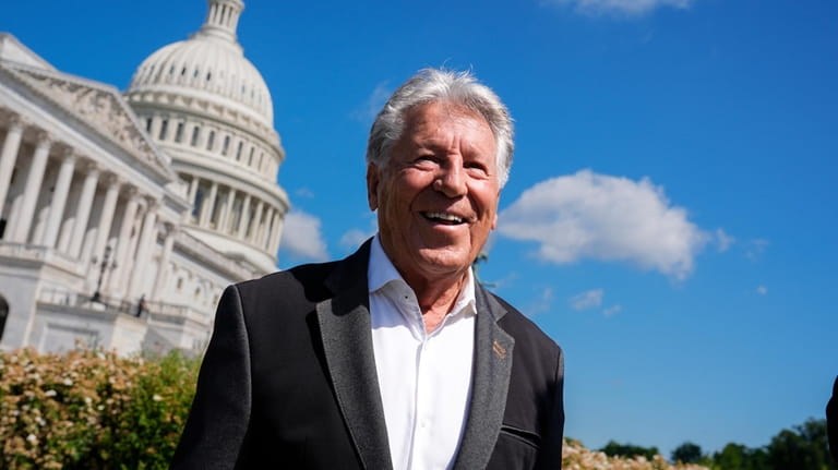 Formula One racing legend Mario Andretti talks to fans following...