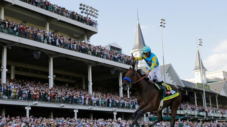 Victor Espinoza rides American Pharoah to victory in the 141st...