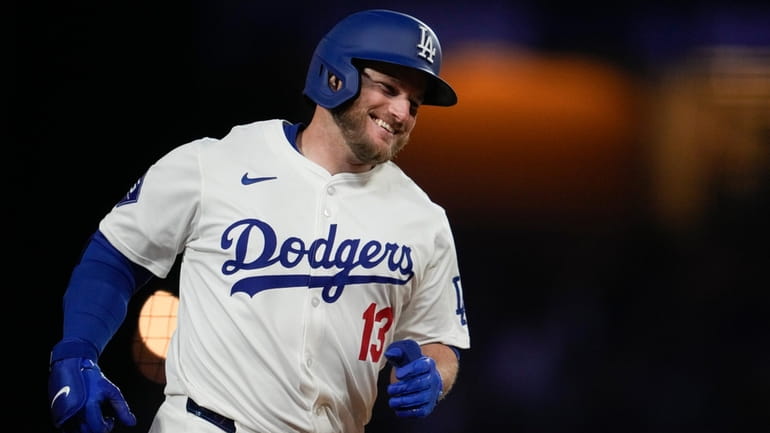 Los Angeles Dodgers' Max Muncy runs the bases after hitting...