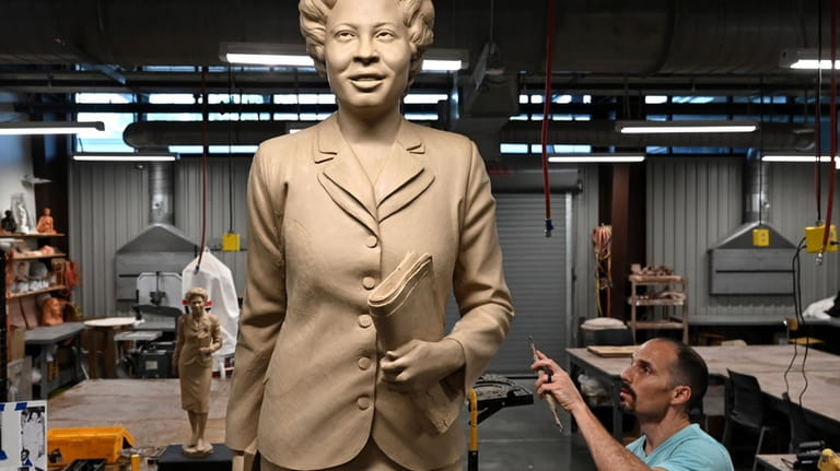 Benjamin Victor works on his sculpture of Daisy Gatson Bates...