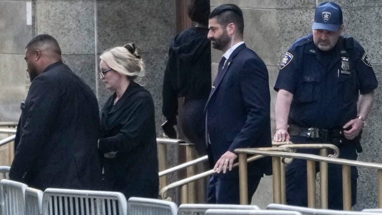 Stormy Daniels, second from left, exits the courthouse in Manhattan,...