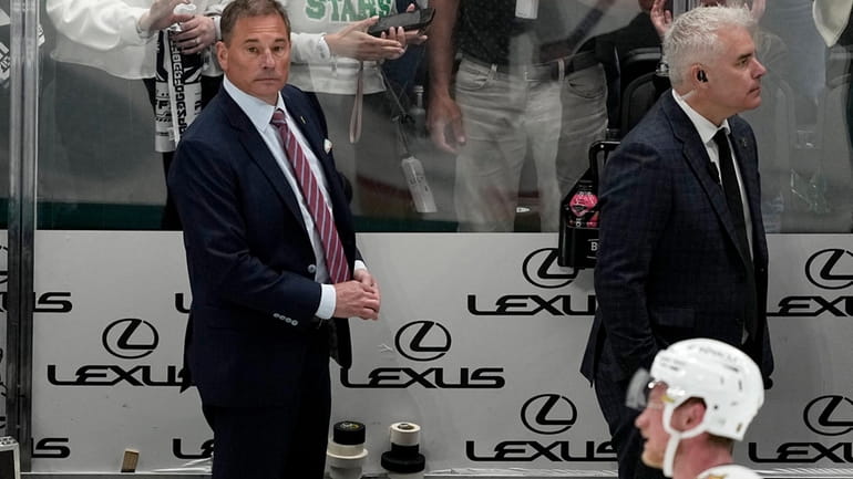 Vegas Golden Knights head coach Bruce Cassidy, left rear, and...