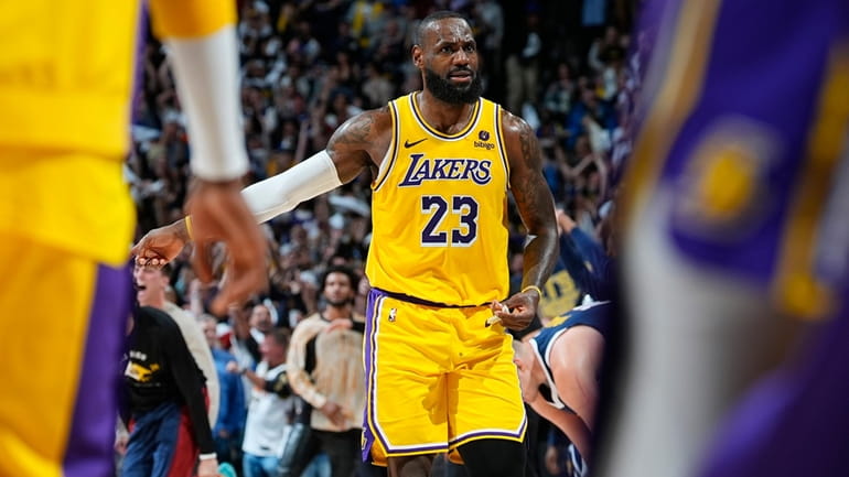 Los Angeles Lakers forward LeBron James reacts as time runs...