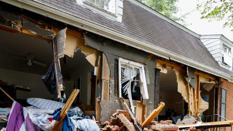 Debris covers a home on Tuesday, April 30, 2024, where...