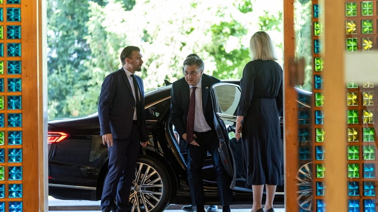 Andrej Plenkovic, centre, arrives to the presidential palace to meet...