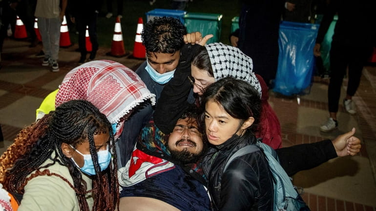 A person is carried away at a pro-Palestinian encampment at...