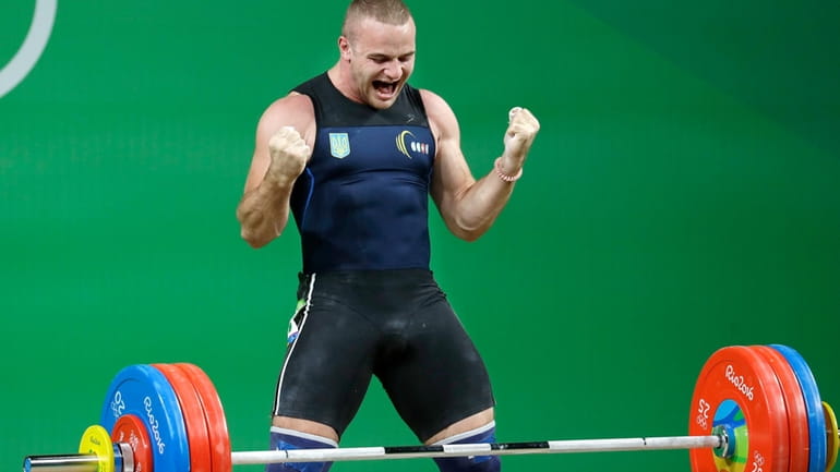 Oleksandr Pielieshenko, of Ukraine, celebrates after a lift in the...