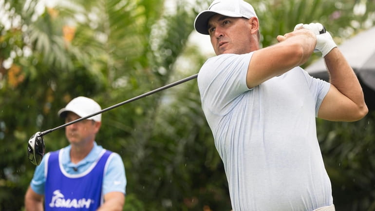 Captain Brooks Koepka, right, of Smash GC, hits on the...