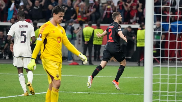 Leverkusen's Josip Stanisic celebrates after scoring during the Europa League...