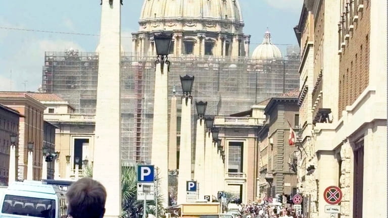 Tourists approaching the Vatican's St. Peter's Basilica Saturday, July 11,...