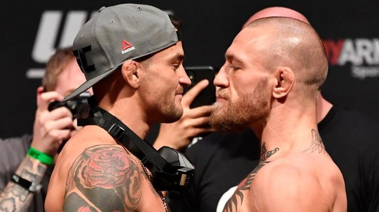 Dustin Poirier, left, and Conor McGregor face off during the...