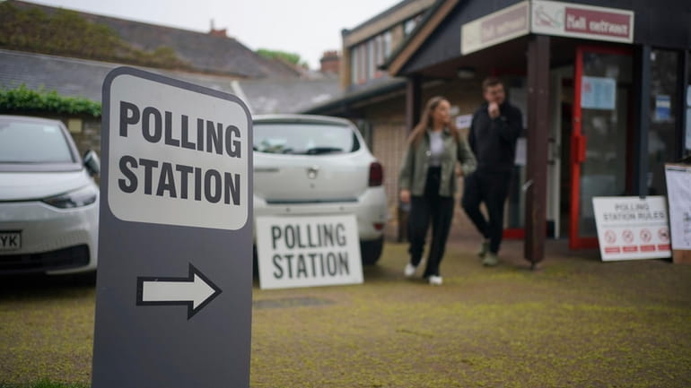 Voters leave a polling station at St Alban's Church, south...