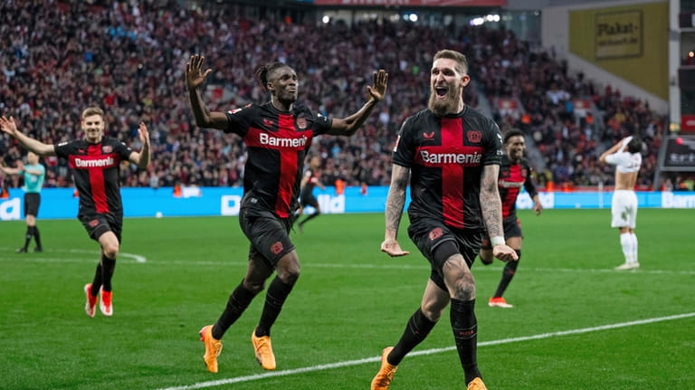 Leverkusen's Robert Andrich, right, celebrates after scoring his side's second...