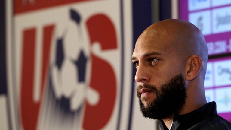 United States goalkeeper Tim Howard talks to reporters before a...