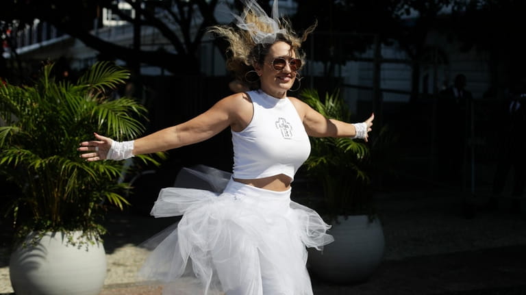 A Madonna fan dances outside Copacabana Palace hotel where Madonna...