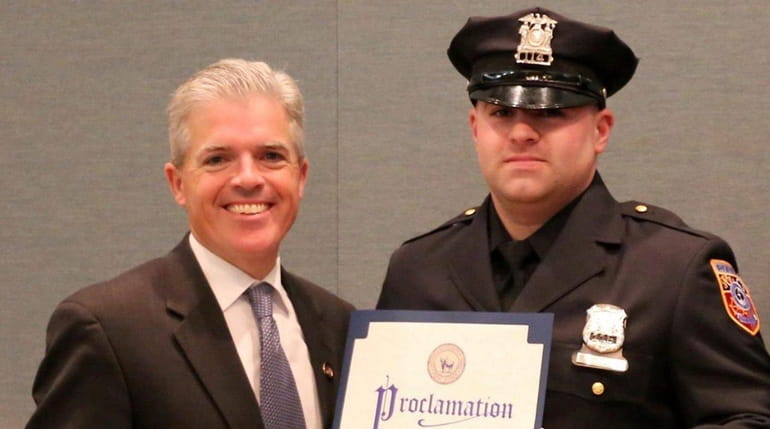 Suffolk County Executive Steve Bellone with Officer Garrett Lake on...