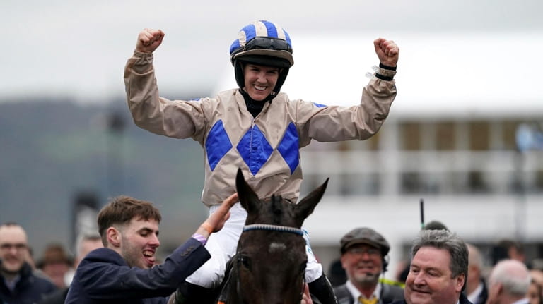 Jockey Rachael Blackmore celebrates onboard Captain Guinness after winning the...