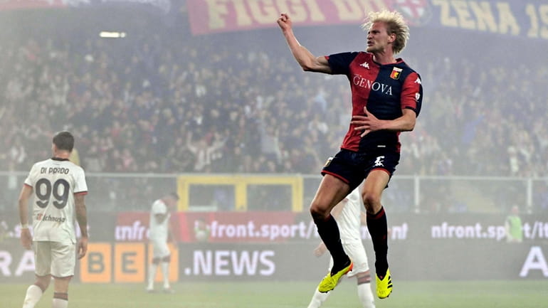 Genoa's Morten Thorsby, front, celebrates after scoring the opening goal...