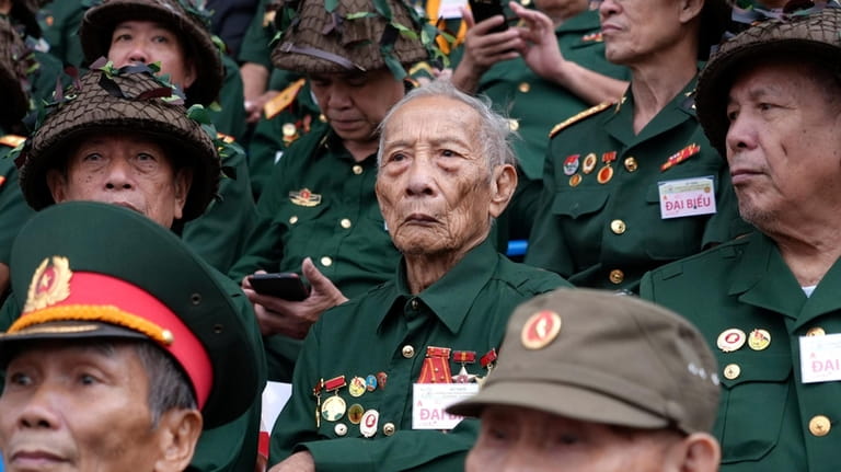 Veterans attend a parade commemorating the victory of Dien Bien...