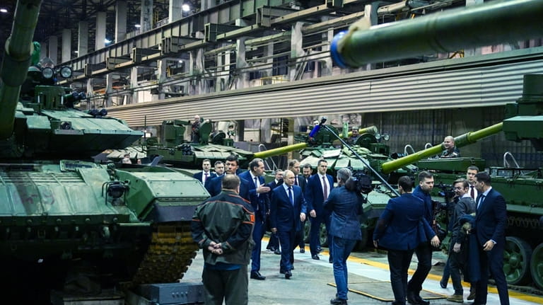 Russian President Vladimir Putin, center, visits the Uralvagonzavod factory in...