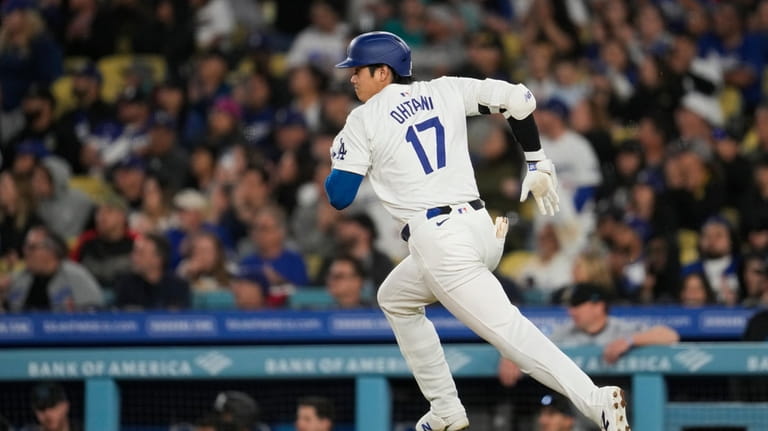 Los Angeles Dodgers designated hitter Shohei Ohtani singles during the...