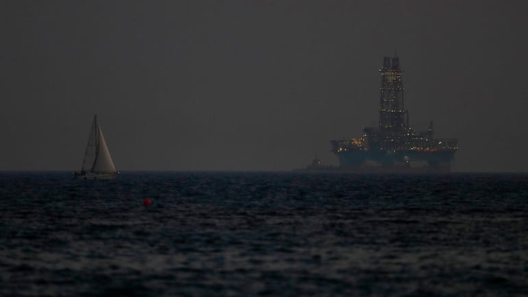 An offshore drilling rig is seen in the waters off...