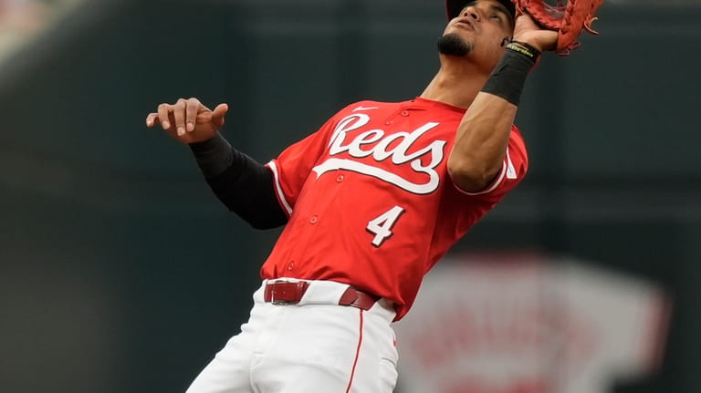 Cincinnati Reds third baseman Santiago Espinal catches a popup hit...
