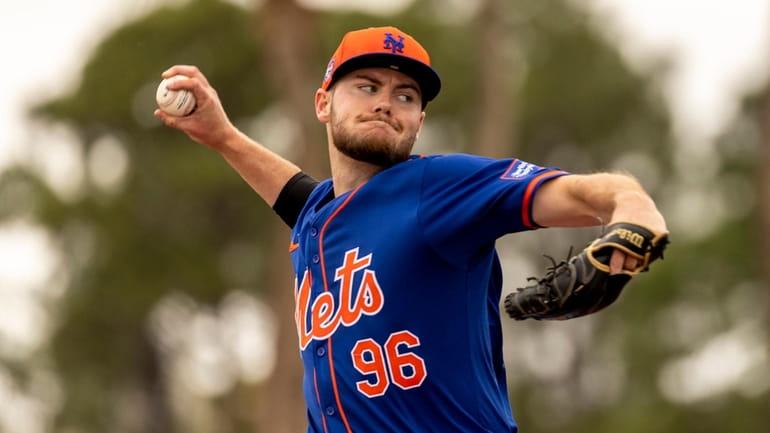 Mets pitcher Christian Scott throws during a spring training workout...