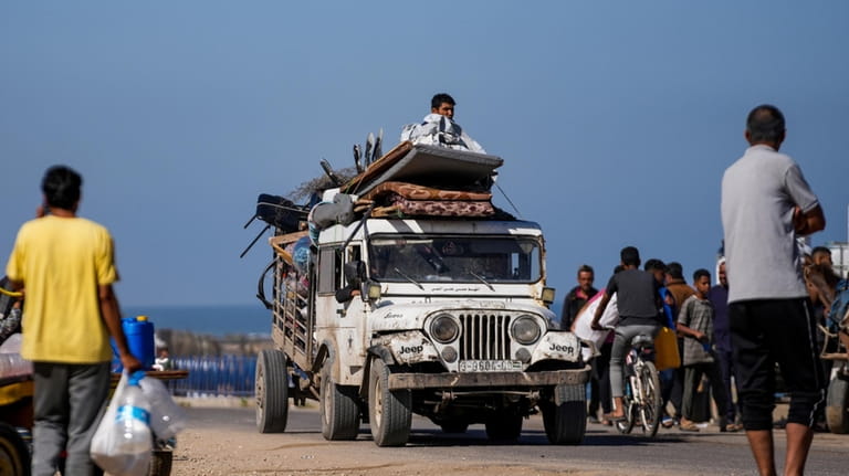Displaced Palestinians arrive in central Gaza after fleeing from the...