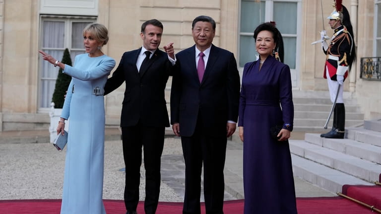 French President Emmanuel Macron and his wife Brigitte Macron pose...