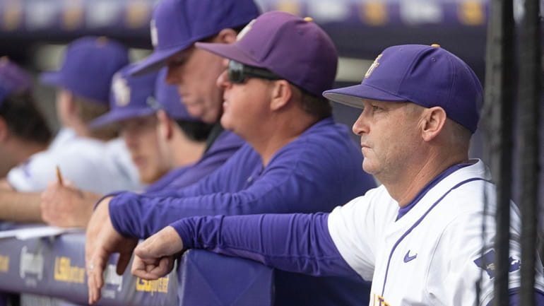 LSU head coach Jay Johnson stands in the dugout before...
