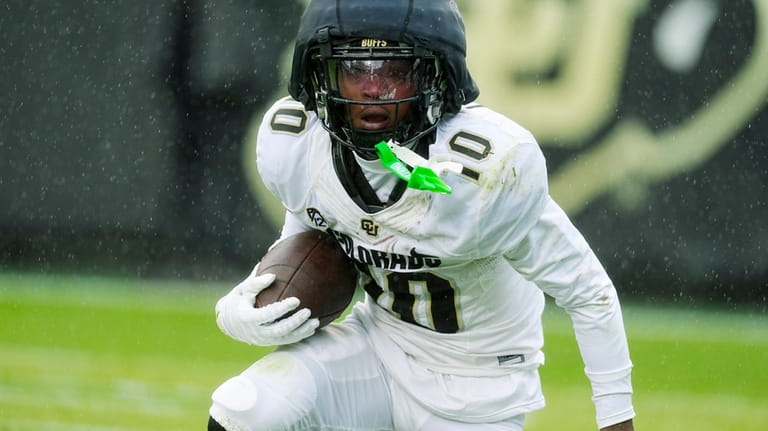 Colorado wide receiver LaJohntay Wester runs after catching a pass...