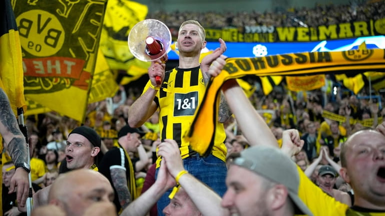 Borussia Dortmund supporters celebrate at the end of the Champions...