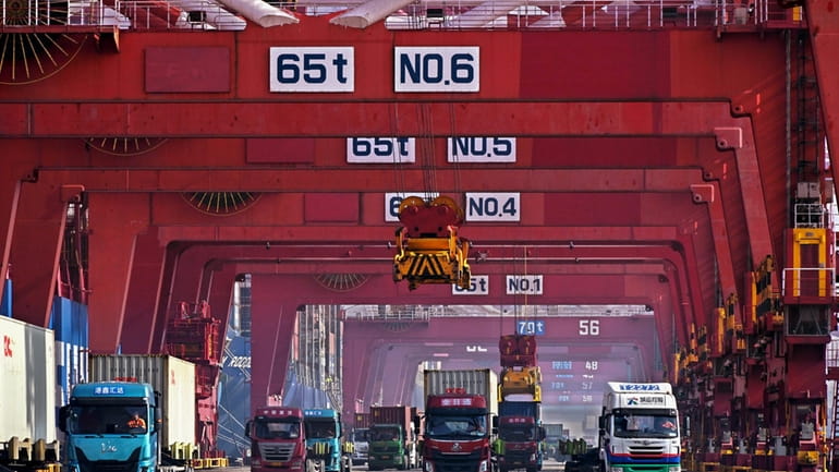 In this photo released by Xinhua News Agency, containers are...