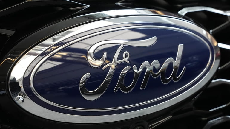 The Ford logo is seen on the grill of a...