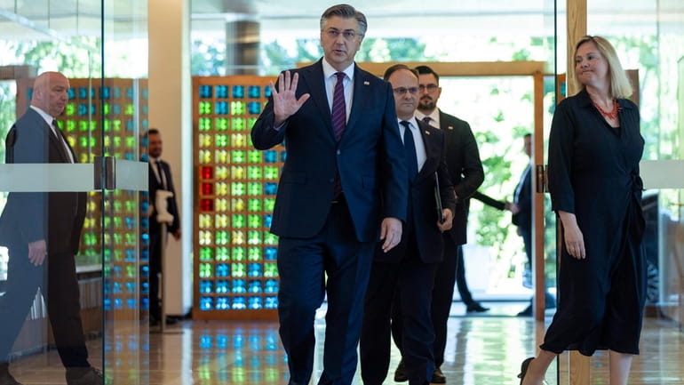 Andrej Plenkovic, centre, arrives to the presidential palace to meet...
