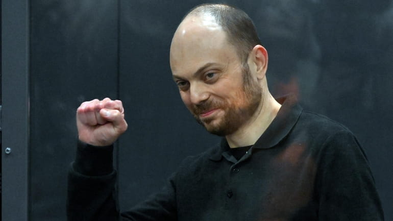 Russian opposition activist Vladimir Kara-Murza gestures standing in a glass...