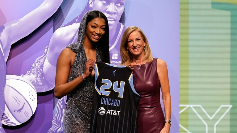 LSU's Angel Reese, left, poses for a photo with WNBA...