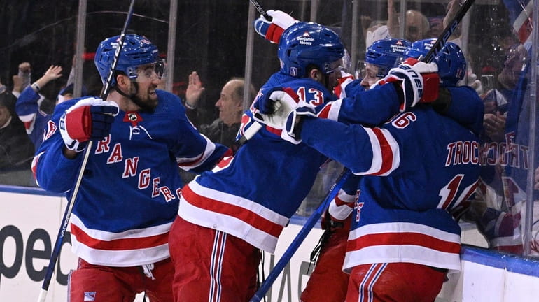 Rangers players celebrate a goal by left wing Artemi Panarin...