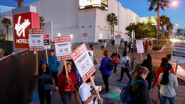 Culinary Local 226 members picket at the start of a...