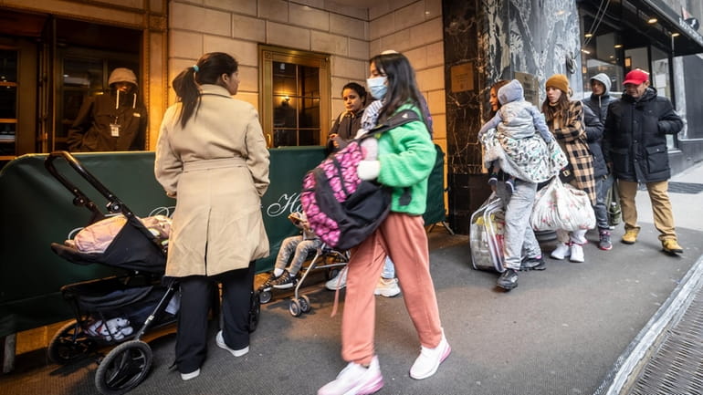 Migrants arrive at the Roosevelt Hotel in Manhattan earlier this...