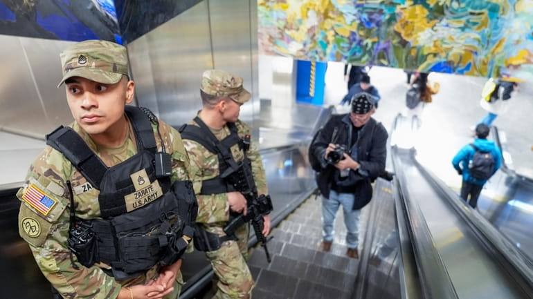 A couple of heavily armed New York National Guard soldiers...