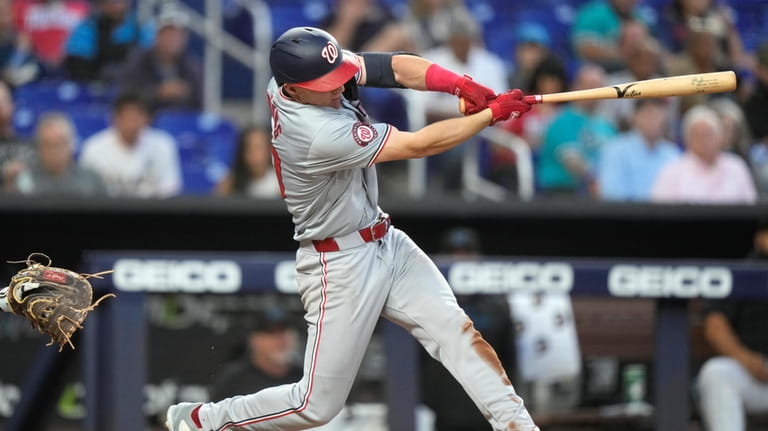 Washington Nationals' Jacob Young hits a single during the fifth...