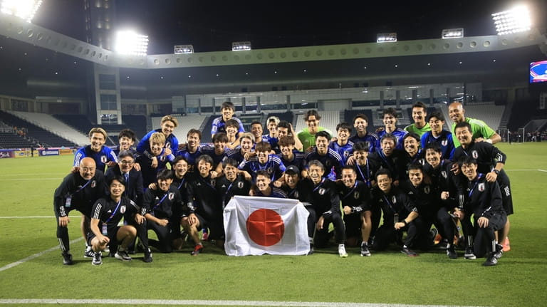 Japan's players pose for a photo after the U-23 Asian...