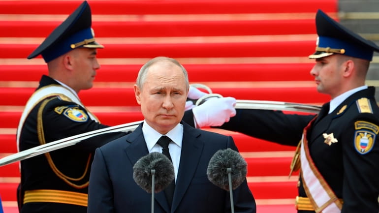 Russian President Vladimir Putin addresses members of the Defense Ministry,...