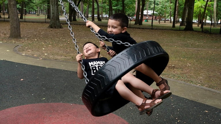 Brothers Jayden, left, and Nickolas Abrego, laugh with glee on...