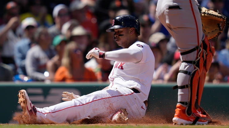 Boston Red Sox's Rafael Devers scores on a double by...
