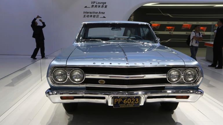 A 1965 Chevrolet Malibu is displayed at the company's booth...